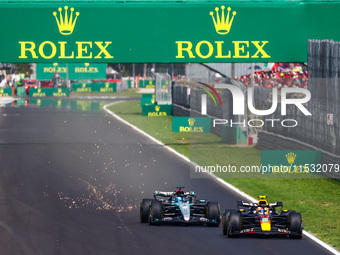 Sergio Perez of Red Bull Racing and George Russell of Mercedes drive on the track during the third practice session, ahead of the Italian Fo...