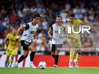 Jesus Vazquez of Valencia CF competes for the ball with Ayoze of Villarreal CF during the LaLiga EA Sports match between Valencia CF and Vil...