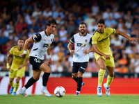 Jesus Vazquez of Valencia CF competes for the ball with Ayoze of Villarreal CF during the LaLiga EA Sports match between Valencia CF and Vil...