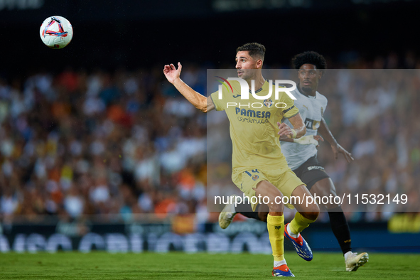 Santi Comesana Veiga of Villarreal CF competes for the ball with Thierry Rendall of Valencia CF during the LaLiga EA Sports match between Va...