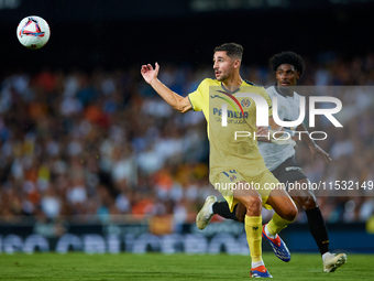 Santi Comesana Veiga of Villarreal CF competes for the ball with Thierry Rendall of Valencia CF during the LaLiga EA Sports match between Va...