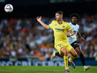 Santi Comesana Veiga of Villarreal CF competes for the ball with Thierry Rendall of Valencia CF during the LaLiga EA Sports match between Va...