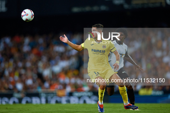 Santi Comesana Veiga of Villarreal CF competes for the ball with Thierry Rendall of Valencia CF during the LaLiga EA Sports match between Va...