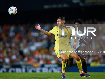 Santi Comesana Veiga of Villarreal CF competes for the ball with Thierry Rendall of Valencia CF during the LaLiga EA Sports match between Va...