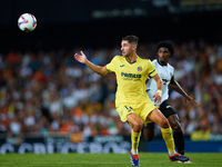 Santi Comesana Veiga of Villarreal CF competes for the ball with Thierry Rendall of Valencia CF during the LaLiga EA Sports match between Va...