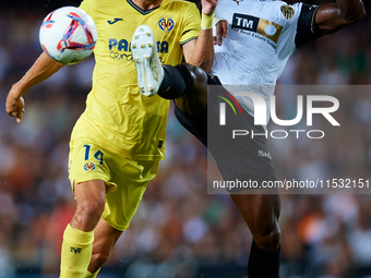 Santi Comesana Veiga of Villarreal CF competes for the ball with Thierry Rendall of Valencia CF during the LaLiga EA Sports match between Va...