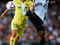 Santi Comesana Veiga of Villarreal CF competes for the ball with Thierry Rendall of Valencia CF during the LaLiga EA Sports match between Va...