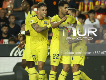 Villarreal's Ayoze Perez Gutierrez celebrates after scoring the 1-1 goal with his teammate during the La Liga match between Valencia CF and...