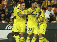 Villarreal's Ayoze Perez Gutierrez celebrates after scoring the 1-1 goal with his teammate during the La Liga match between Valencia CF and...