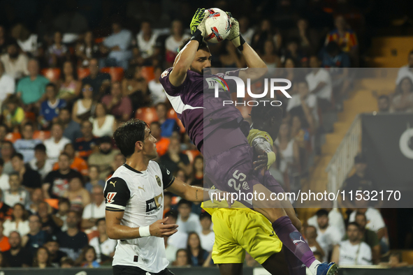 Giorgi Mamardashvili of Valencia CF jumps for the ball during the La Liga match between Valencia CF and Villarreal CF at Mestalla Stadium in...