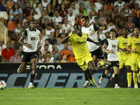 Villarreal's Thierno Mamadou Barry (L) and Hugo Duro of Valencia CF (R) during the La Liga match between Valencia CF and Villarreal CF at Me...