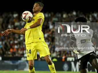 Villarreal's Santi Comesana (left) and Thierry Correia of Valencia CF during the La Liga match between Valencia CF and Villarreal CF at Mest...