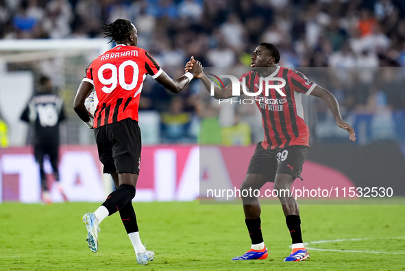 Tammy Abraham of AC Milan celebrates with Youssouf Fofana after Rafael Leao scored second goal during the Serie A Enilive match between SS L...