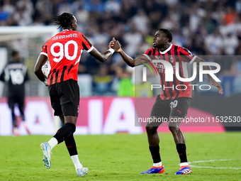 Tammy Abraham of AC Milan celebrates with Youssouf Fofana after Rafael Leao scored second goal during the Serie A Enilive match between SS L...