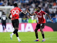 Tammy Abraham of AC Milan celebrates with Youssouf Fofana after Rafael Leao scored second goal during the Serie A Enilive match between SS L...