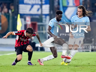 Christian Pulisic of AC Milan and Boulaye Dia of SS Lazio compete for the ball during the Serie A Enilive match between SS Lazio and AC Mila...