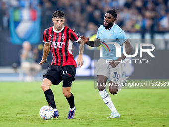 Christian Pulisic of AC Milan and Nuno Tavares of SS Lazio compete for the ball during the Serie A Enilive match between SS Lazio and AC Mil...