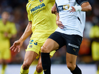 Diego Lopez (R) of Valencia CF competes for the ball with Sergi Cardona of Villarreal CF during the LaLiga EA Sports match between Valencia...