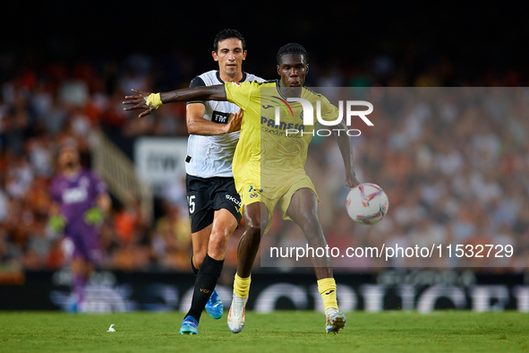 Thierno Barry of Villarreal CF competes for the ball with Cesar Tarrega of Valencia CF during the LaLiga EA Sports match between Valencia CF...