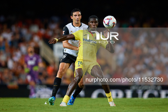 Thierno Barry of Villarreal CF competes for the ball with Cesar Tarrega of Valencia CF during the LaLiga EA Sports match between Valencia CF...