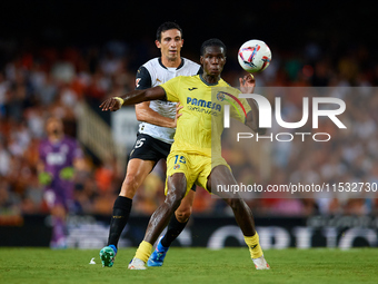 Thierno Barry of Villarreal CF competes for the ball with Cesar Tarrega of Valencia CF during the LaLiga EA Sports match between Valencia CF...