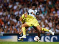 Ramon Terrats of Villarreal CF competes for the ball with Thierry Rendall of Valencia CF during the LaLiga EA Sports match between Valencia...