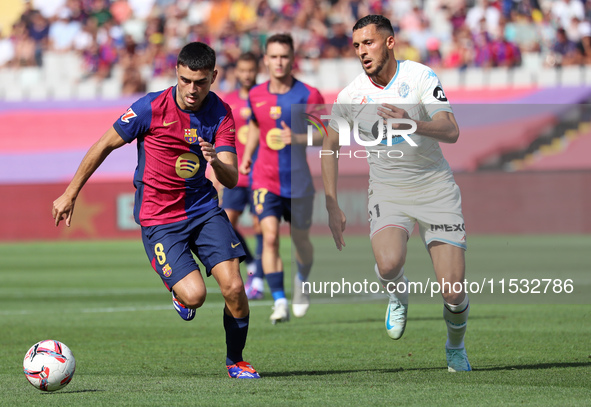 Pedri and Selim Amallah play during the match between FC Barcelona and Real Valladolid CF, corresponding to week 4 of LaLiga EA Sports, at t...