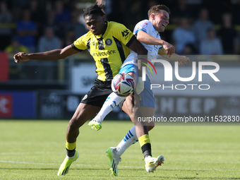 Harrogate Town's Sam Folarin is fouled by Barrow's Robbie Gotts during the Sky Bet League 2 match between Harrogate Town and Barrow at Wethe...