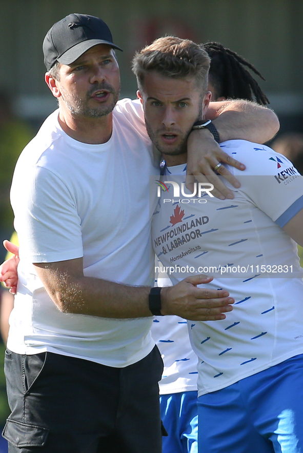 Barrow Manager Stephen Clemence and Barrow's Andrew Dallas embrace at full time during the Sky Bet League 2 match between Harrogate Town and...