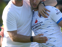 Barrow Manager Stephen Clemence and Barrow's Andrew Dallas embrace at full time during the Sky Bet League 2 match between Harrogate Town and...