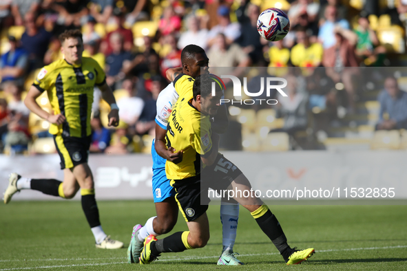 Barrow's Emile Acquah fouls Harrogate Town's Anthony O'Connor during the Sky Bet League 2 match between Harrogate Town and Barrow at Wetherb...