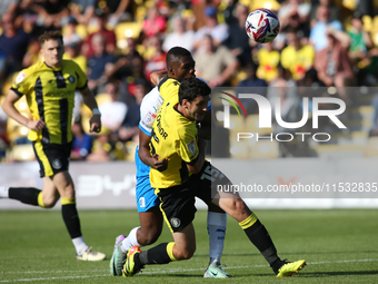 Barrow's Emile Acquah fouls Harrogate Town's Anthony O'Connor during the Sky Bet League 2 match between Harrogate Town and Barrow at Wetherb...