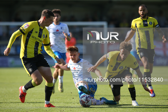 Barrow's Ged Garner is fouled by Harrogate Town's Stephen Duke-McKenna during the Sky Bet League 2 match between Harrogate Town and Barrow a...