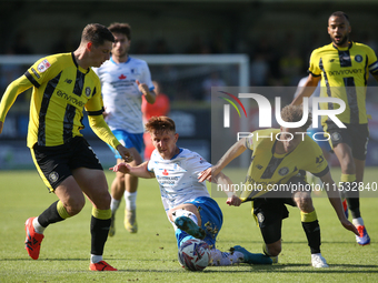 Barrow's Ged Garner is fouled by Harrogate Town's Stephen Duke-McKenna during the Sky Bet League 2 match between Harrogate Town and Barrow a...