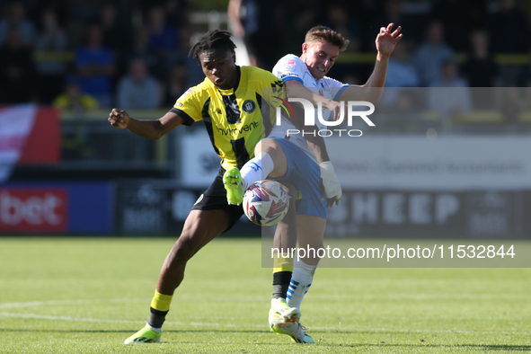 Barrow's Robbie Gotts wins the ball from Harrogate Town's Sam Folarin during the Sky Bet League 2 match between Harrogate Town and Barrow at...