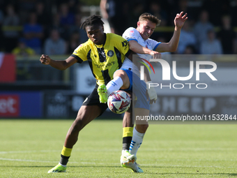 Barrow's Robbie Gotts wins the ball from Harrogate Town's Sam Folarin during the Sky Bet League 2 match between Harrogate Town and Barrow at...