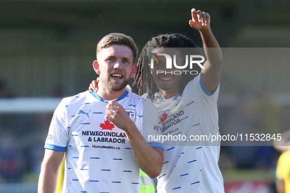 Barrow's Ben Jackson and Barrow's Neo Eccleston celebrate at full time during the Sky Bet League 2 match between Harrogate Town and Barrow a...