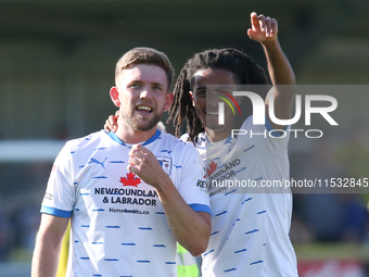 Barrow's Ben Jackson and Barrow's Neo Eccleston celebrate at full time during the Sky Bet League 2 match between Harrogate Town and Barrow a...