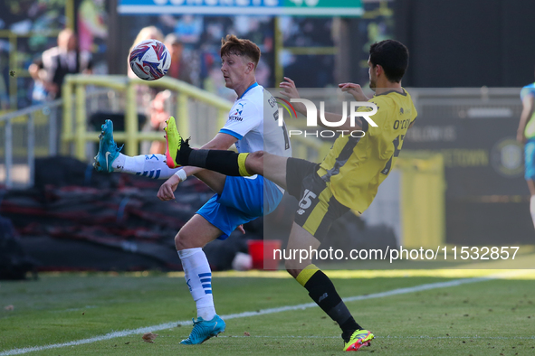 Barrow's Ged Garner chips a ball over Harrogate Town's Anthony O'Connor during the Sky Bet League 2 match between Harrogate Town and Barrow...