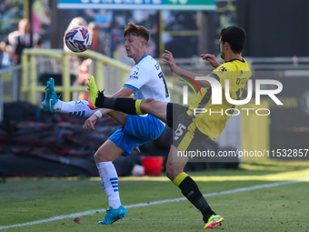 Barrow's Ged Garner chips a ball over Harrogate Town's Anthony O'Connor during the Sky Bet League 2 match between Harrogate Town and Barrow...