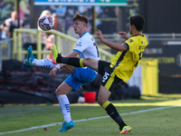 Barrow's Ged Garner chips a ball over Harrogate Town's Anthony O'Connor during the Sky Bet League 2 match between Harrogate Town and Barrow...