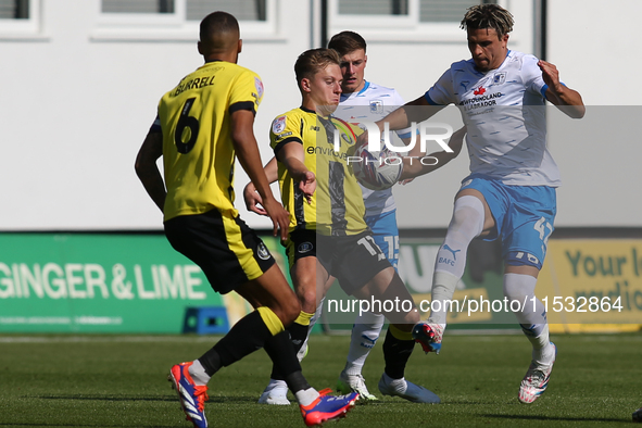 Theo Vassell of Barrow challenges James Daly of Harrogate Town during the Sky Bet League 2 match between Harrogate Town and Barrow at Wether...