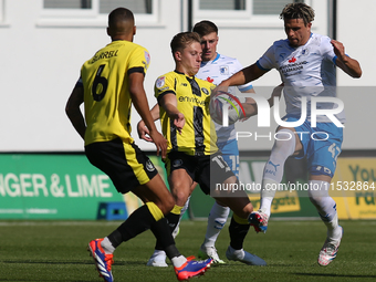 Theo Vassell of Barrow challenges James Daly of Harrogate Town during the Sky Bet League 2 match between Harrogate Town and Barrow at Wether...