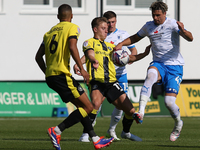 Theo Vassell of Barrow challenges James Daly of Harrogate Town during the Sky Bet League 2 match between Harrogate Town and Barrow at Wether...