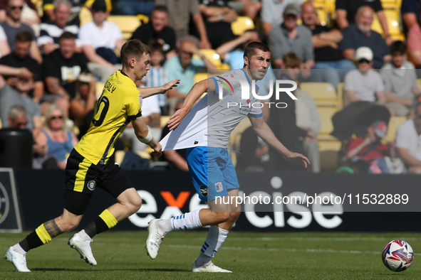 Harrogate Town's Matty Daly holds the shirt of Barrow's Dean Campbell during the Sky Bet League 2 match between Harrogate Town and Barrow at...