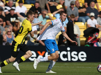 Harrogate Town's Matty Daly holds the shirt of Barrow's Dean Campbell during the Sky Bet League 2 match between Harrogate Town and Barrow at...