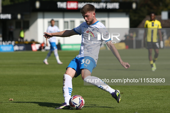 Ben Jackson of Barrow crosses a ball during the Sky Bet League 2 match between Harrogate Town and Barrow at Wetherby Road in Harrogate, Engl...