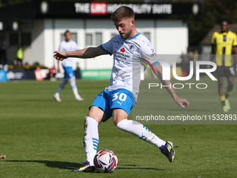 Ben Jackson of Barrow crosses a ball during the Sky Bet League 2 match between Harrogate Town and Barrow at Wetherby Road in Harrogate, Engl...