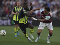 Jeremy Doku of Manchester City battles for possession with Lucas Paqueta of West Ham United during the Premier League match between West Ham...