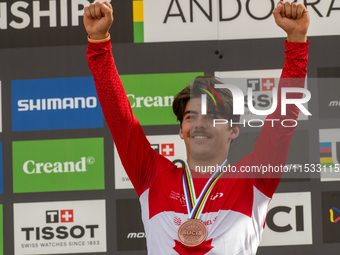 Finn Iles of Canada stands on the podium at the UCI Mountain Bike World Championships Women Downhill in Pal Arinsal, Andorra, on August 31,...